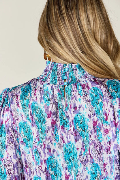 Printed smocked long sleeve blouse by Trendsi featuring a double take full size design with a stylish, fitted silhouette.