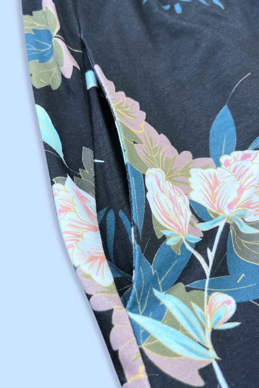 Printed sleeveless casual dress by Trendsi featuring front buttons, ruched waist, side slit, and pockets.