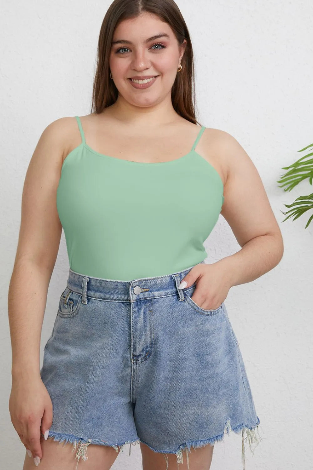 Plus size basic Bae full-size round neck slim cami from Trendsi, shown in black with a fitted, sleeveless design.