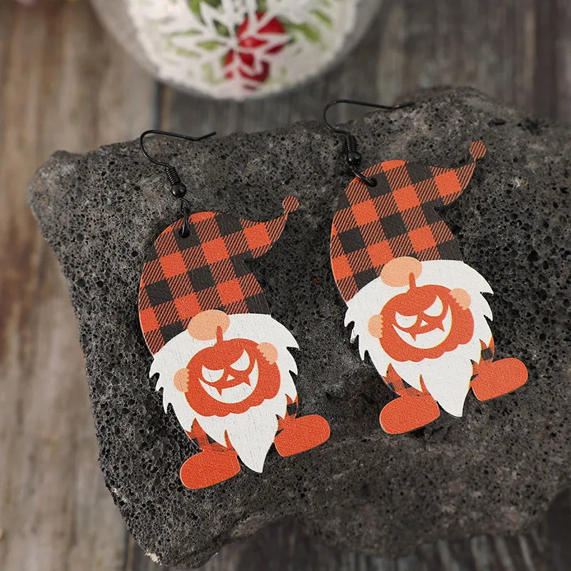 Wooden dwarf pumpkin dangle earrings featuring carved pumpkin design, perfect for fall or Halloween fashion accessories.