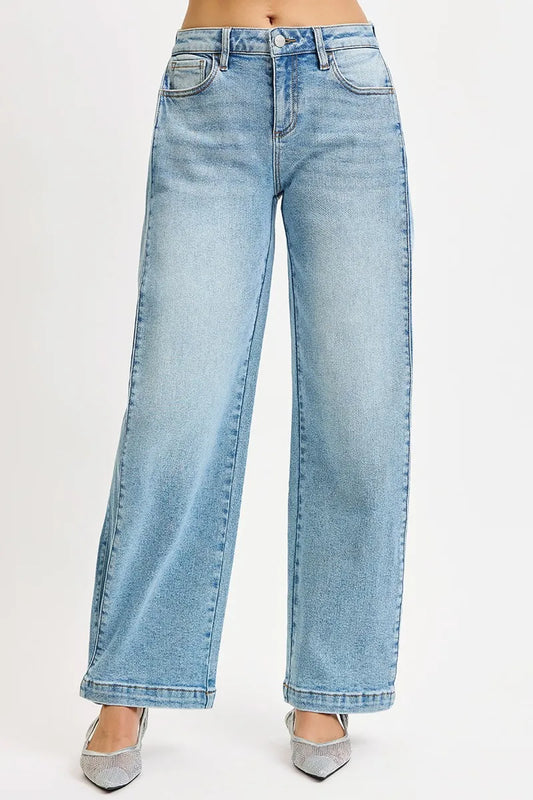 Risen mid-rise wide barrel transfer leg snap jeans in dark wash with distressed details and adjustable leg snaps, casual denim style.