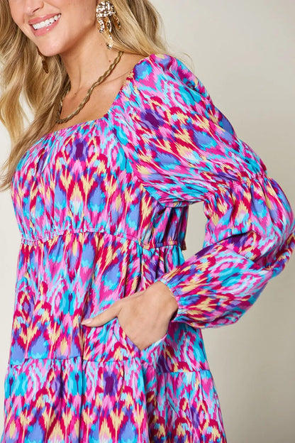 Printed long sleeve dress from Trendsi's Double Take collection, full size, with a stylish, fitted silhouette and vibrant pattern.