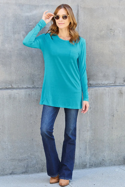 Basic Bae full size round neck long sleeve top by Trendsi, shown in a neutral color, close-up of the soft fabric and fit.