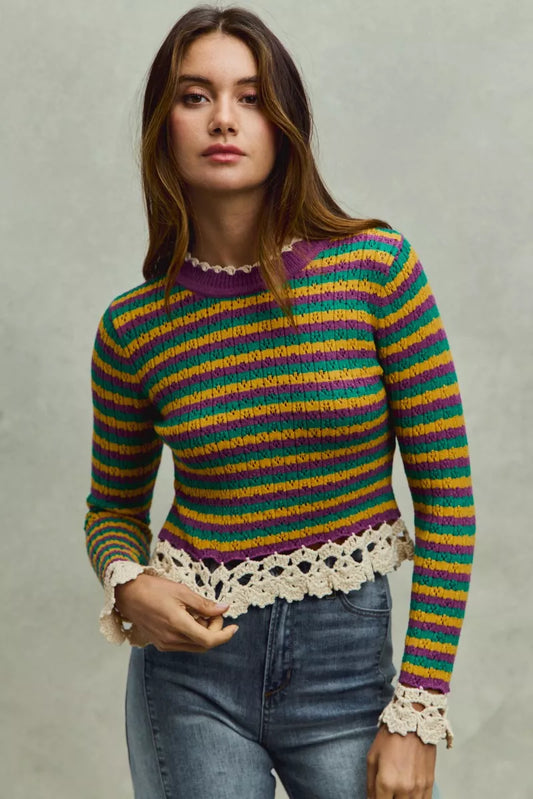 Striped Mardi Gras cropped knit top with crochet edge, trendy fashion piece by Trendsi, shown in a close-up image.