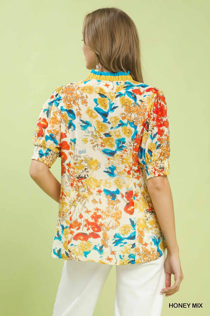 Umgee floral contrast pleat neck top featuring a pleated neckline and a floral print, perfect for casual or dressy occasions.