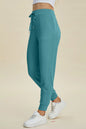 Basic Bae full size air scuba high waist joggers with drawstring, black color, made by Trendsi, shown on a model.