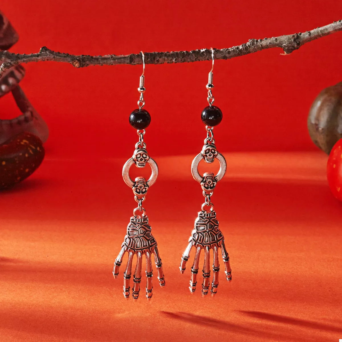 Halloween Skeleton Hand Drop Earrings featuring gothic-style skeletal hands hanging from silver hooks, perfect for spooky accessories.