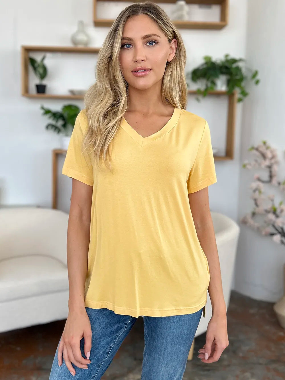 Basic Bae bamboo V-neck high-low T-shirt by Trendsi, full size, lightweight, natural fabric, displayed on a hanger.