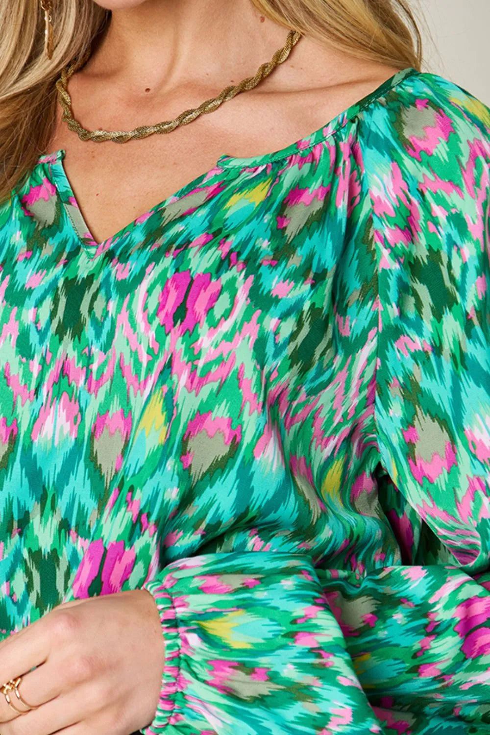 Printed balloon sleeve blouse from the Double Take collection by Trendsi, showcasing a full-size, stylish design with vibrant patterns.