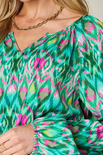 Printed balloon sleeve blouse from the Double Take collection by Trendsi, showcasing a full-size, stylish design with vibrant patterns.