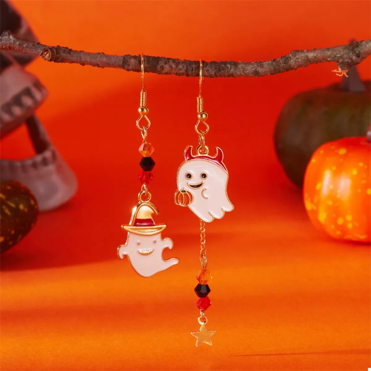 Halloween Ghost Pumpkin Drop Earrings by Trendsi featuring spooky ghost and pumpkin charms hanging from silver hooks.