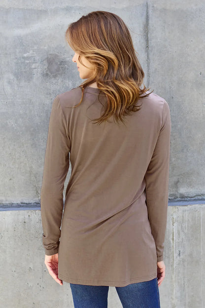 Trendsi Basic Bae full-size round neck long sleeve top in a neutral color, displayed on a hanger.