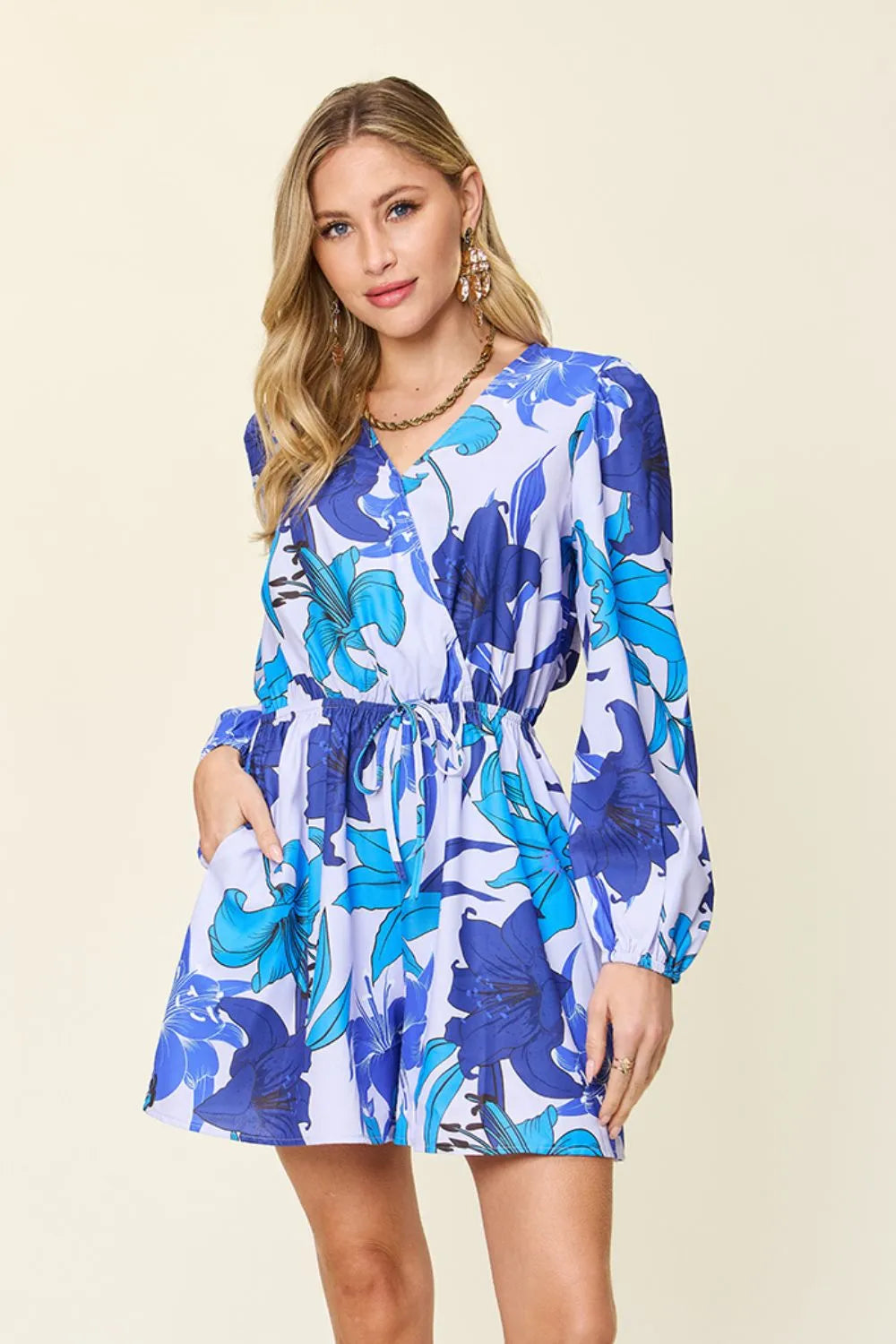 Max floral long sleeve romper with pockets from Trendsi, featuring a full size, stylish design and vibrant floral pattern.