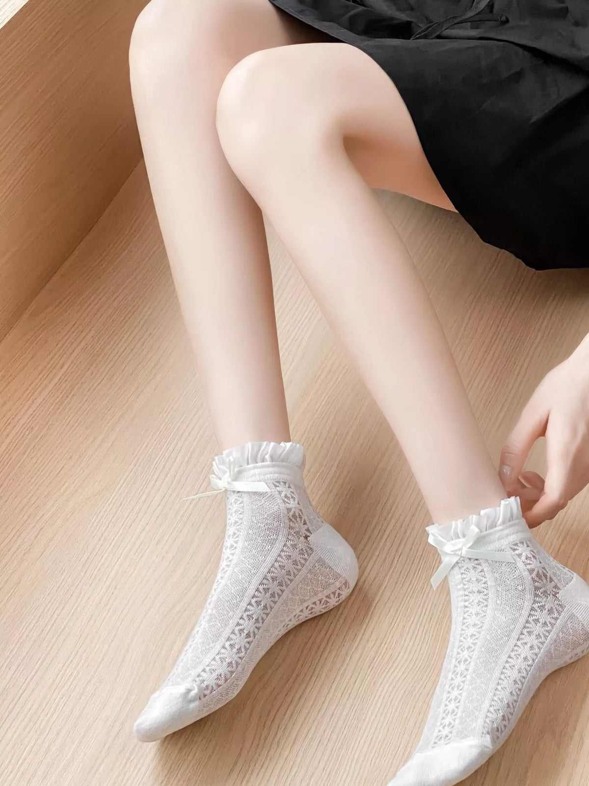 White lace bow socks by Trendsi featuring delicate lace and bow detail, perfect for adding a feminine touch to any outfit.