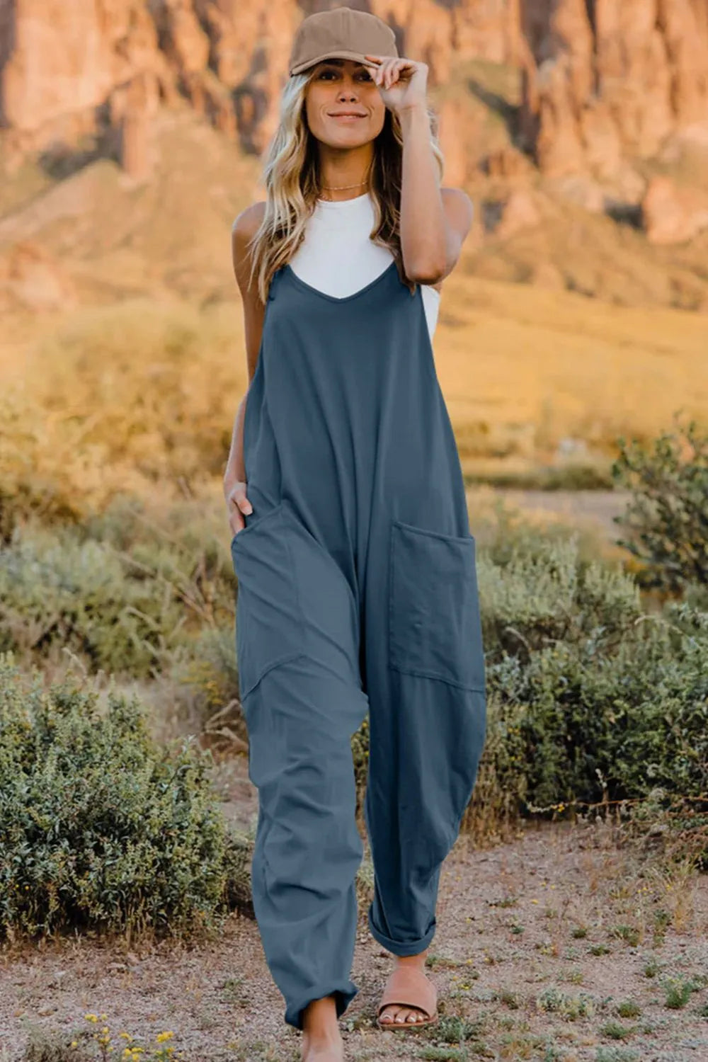 Full-size V-neck sleeveless jumpsuit with pockets by Trendsi, featuring a stylish fit and comfortable design.