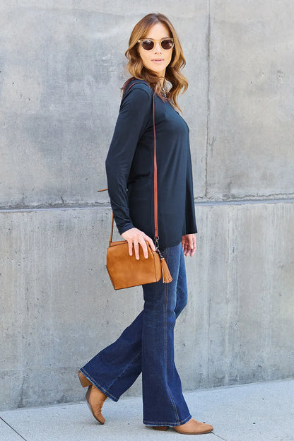 Long sleeve round neck top from Trendsi's Basic Bae collection, showcasing a classic fit and soft fabric in a neutral color.