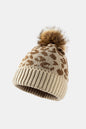 Leopard print pom-pom cuffed beanie by Trendsi featuring a cozy knit design and playful leopard pattern.