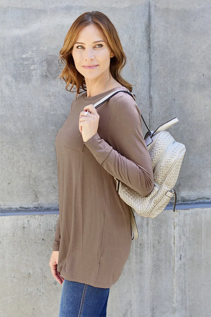 Basic Bae long sleeve round neck top by Trendsi, showing a close-up of the soft, fitted fabric in a neutral color.