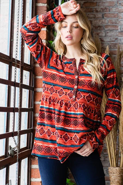 Heimish long sleeve babydoll top with geometric buttons, made of soft fabric, featuring a relaxed fit and stylish design.