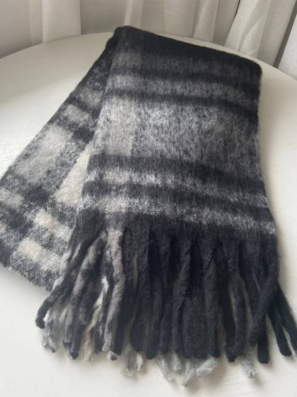 Trendsi fringe plaid polyester scarf with tassels, featuring a colorful plaid pattern and soft fabric for stylish warmth.