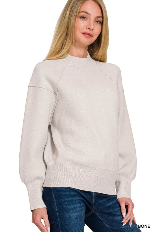 Zenana viscose mock neck sweater with exposed seam detail, shown in a close-up view highlighting the fabric and neck design.