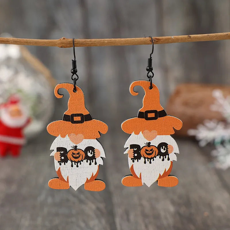 Wooden dwarf pumpkin dangle earrings with carved detailing, featuring a rustic design perfect for fall accessories.
