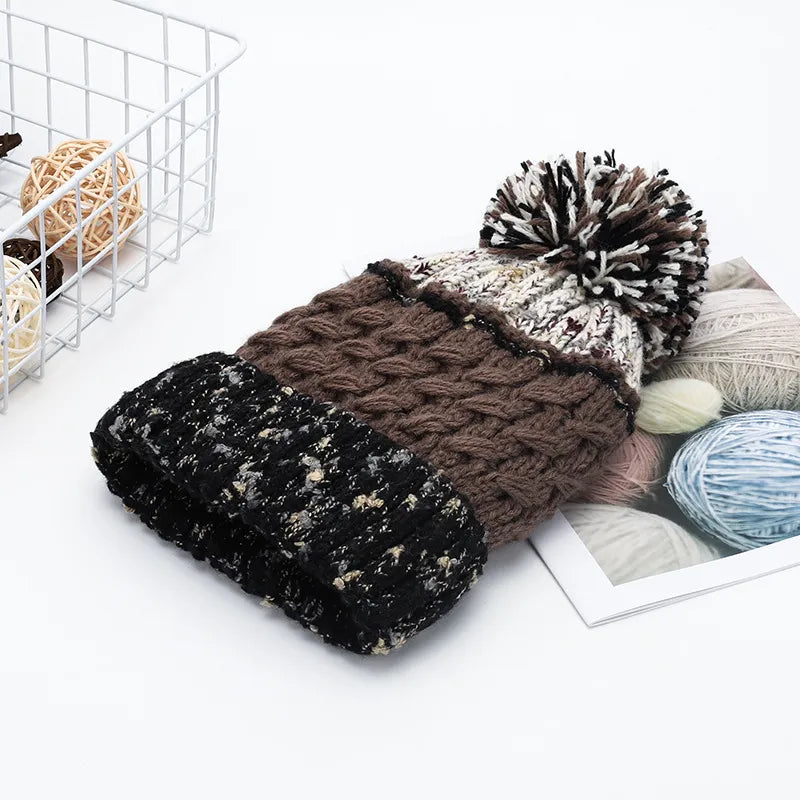 Contrast thermal hat with pompom from Trendsi featuring a cozy knit design and a playful pompom on top.