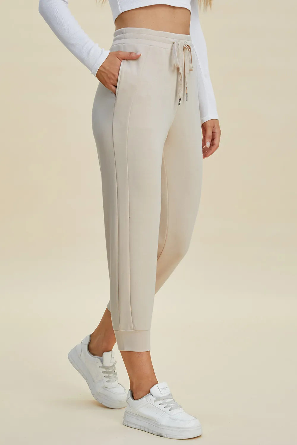 Basic Bae full size air scuba drawstring high waist cropped pants by Trendsi, shown in black with elastic waistband and cropped length.