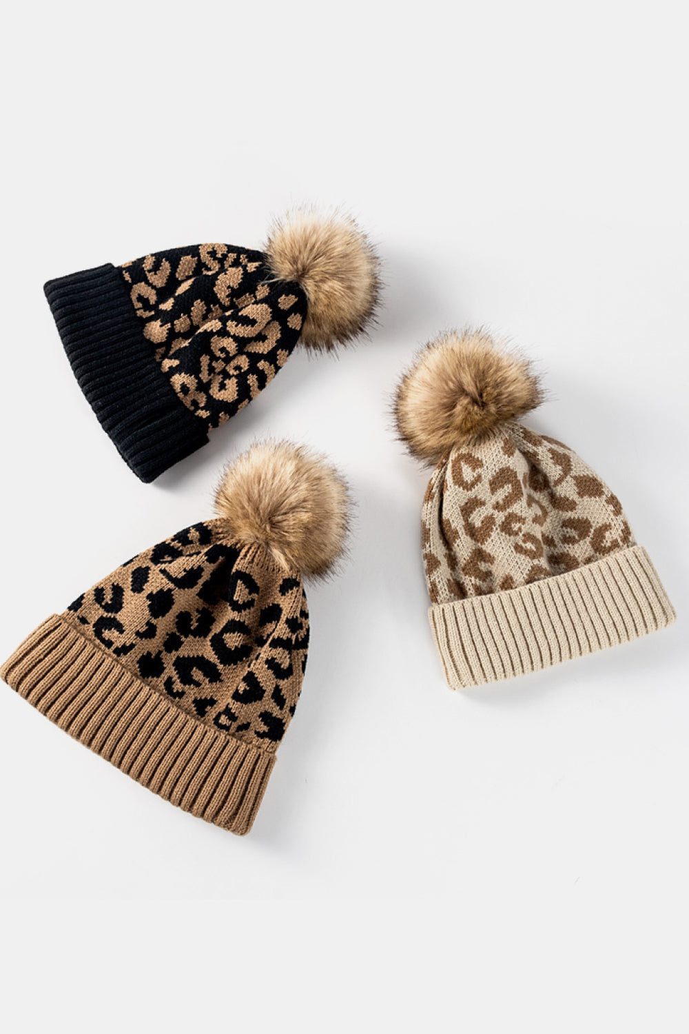 Leopard print pom-pom cuffed beanie by Trendsi, cozy knit hat with faux fur pom-pom and leopard pattern for stylish winter wear.
