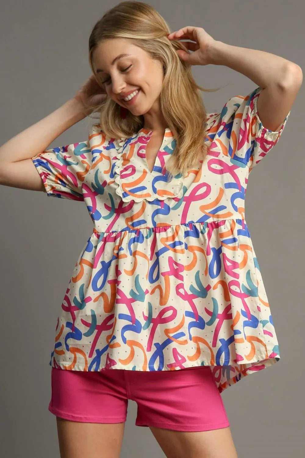 Plus size Umgee puff sleeve babydoll blouse with mixed print, lightweight fabric, and relaxed fit, styled with trendy details.