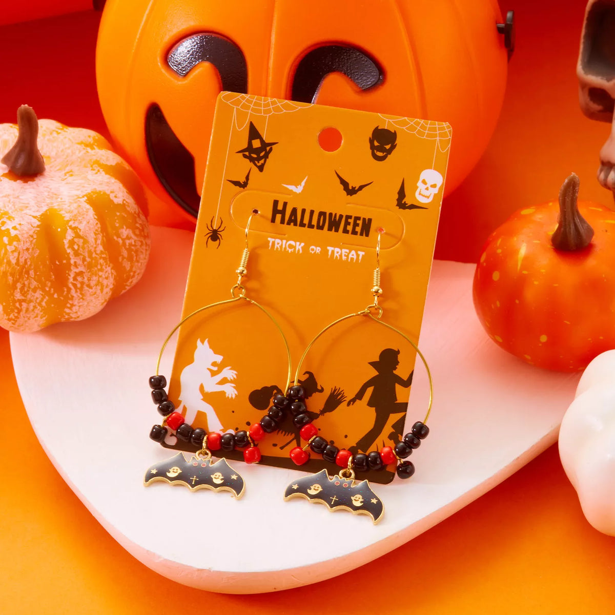 Halloween bat charm hoop earrings by Trendsi featuring black metal hoops with bat-shaped charms, perfect for spooky seasonal style.