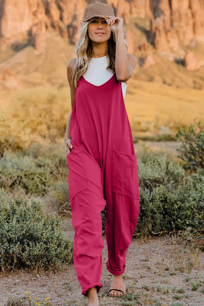 Trendsi Double Take sleeveless v-neck jumpsuit with full size fit and pockets, shown on a model in a casual indoor setting.
