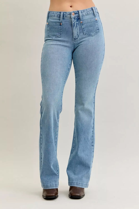 Plus size Judy Blue bootcut jeans with mid rise, contrast wash, and front patch pockets, shown in a full-length view.