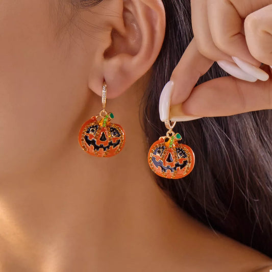 Halloween pumpkin drop earrings featuring orange pumpkin charms and gold hooks, perfect for festive fall accessories.
