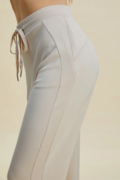 Trendsi Basic Bae full-size air scuba drawstring high waist cropped pants in black, featuring a relaxed fit and elastic waistband.
