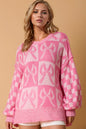 Double Take full-size checkered bow contrast long sleeve sweater by Trendsi, featuring a stylish checkered pattern and bow detail.