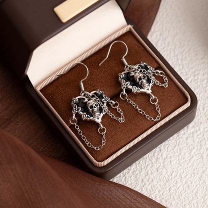 Halloween alloy heart skull earrings with chain detail, featuring gothic style jewelry from Trendsi.