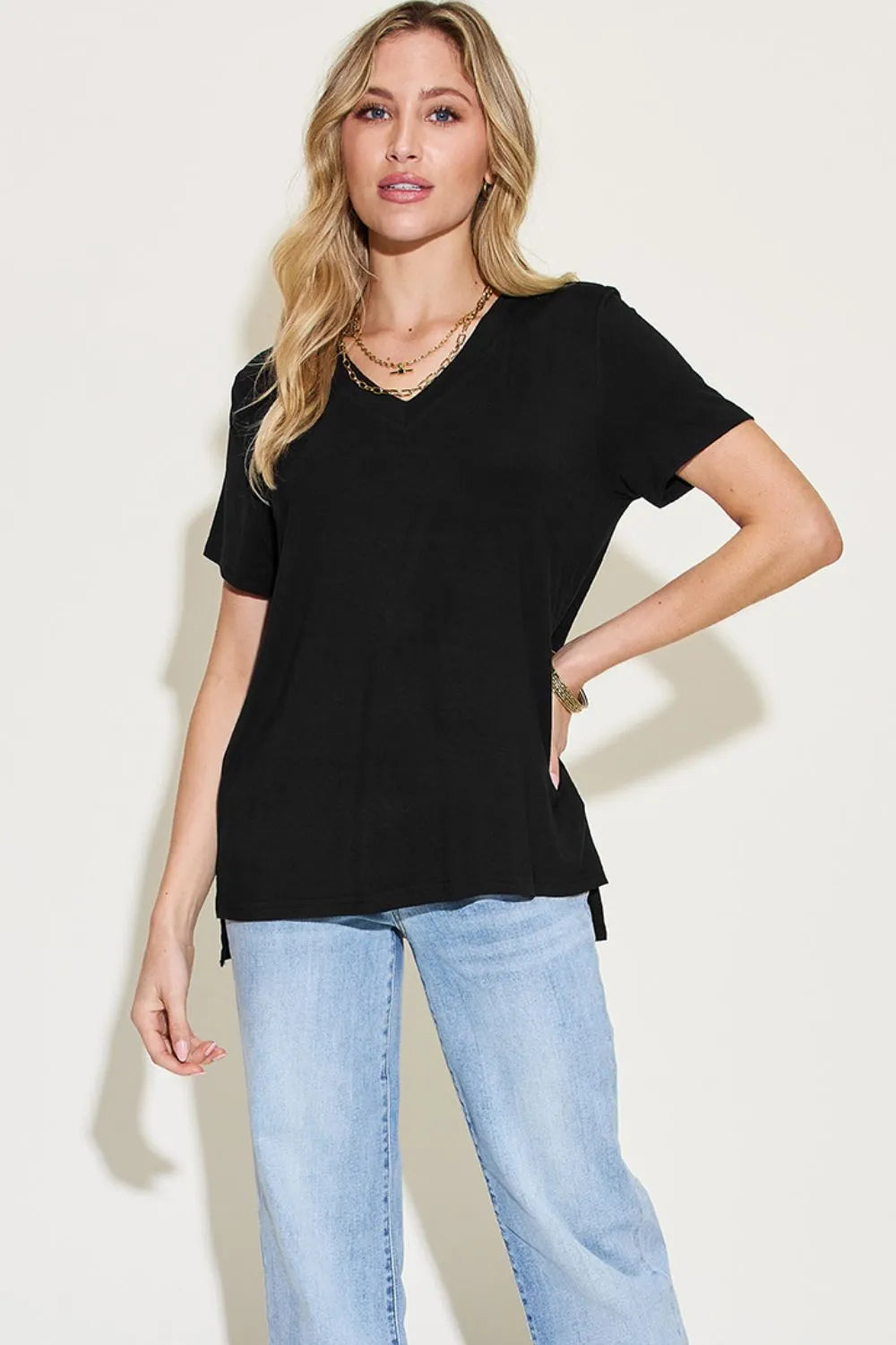Basic Bae full size V-neck high-low T-shirt by Trendsi, showing the front view with a relaxed fit and V-neck neckline.