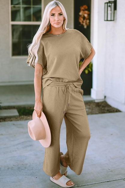 Trendsi double take full size textured short sleeve top and matching pants set with a relaxed fit and stylish design.