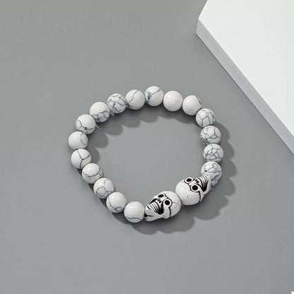Halloween skull beaded bracelet with black and metallic beads, stylish jewelry accessory from Trendsi.