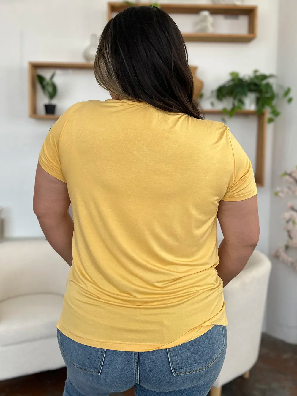 Basic Bae bamboo full-size V-neck high-low T-shirt by Trendsi, shown in natural bamboo fabric with V-neck and high-low hem.