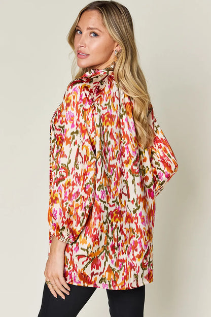 Plus size printed button-up long sleeve shirt from Trendsi, featuring a stylish full-size design and vibrant pattern.