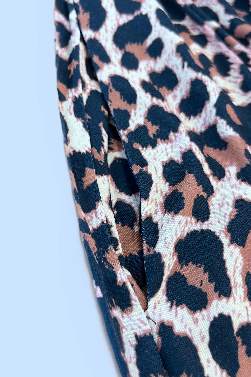 Printed sleeveless casual dress by Trendsi featuring front buttons, ruched waist, side slit, and pockets.