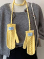 Cable knitted mittens with neck strap from Trendsi, featuring a cozy, textured knit pattern and adjustable strap for comfort.