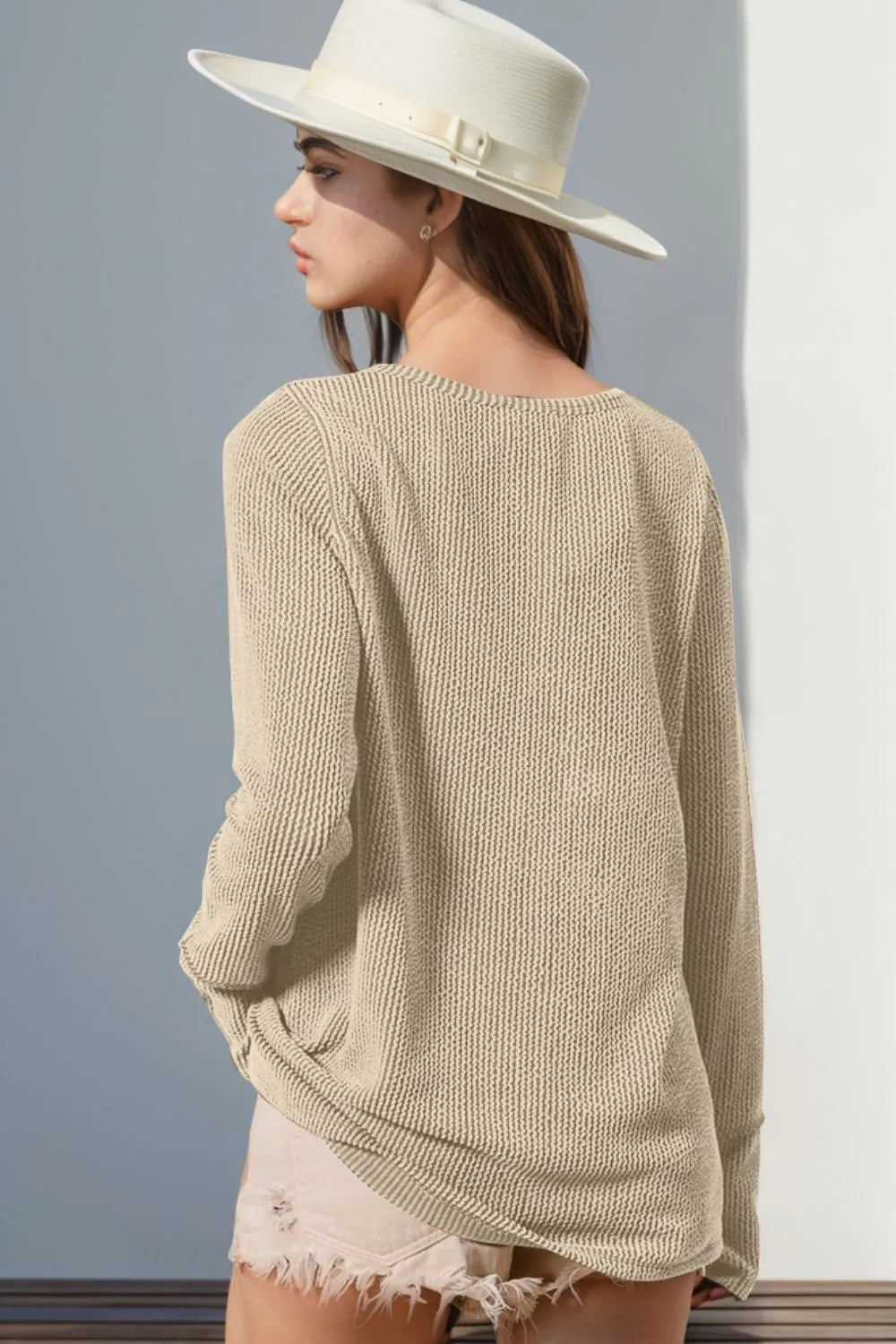 Long sleeve T-shirt by Trendsi featuring notched thumbhole details and a casual, fitted design. White fabric with a soft texture.