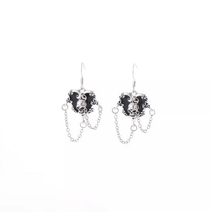Halloween alloy heart skull earrings with chain detail, featuring gothic design and silver-tone finish, by Trendsi.