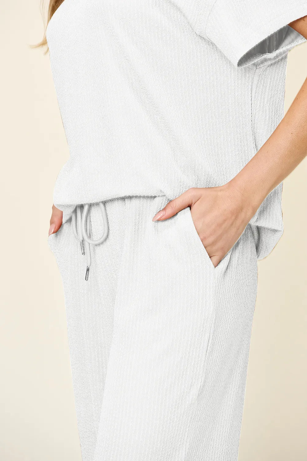 Trendsi Double Take textured round neck short sleeve T-shirt paired with wide-leg pants, casual and stylish outfit for everyday wear.