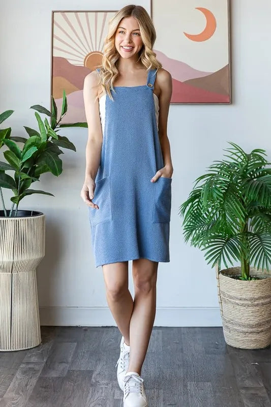 Heimish full-size ribbed sleeveless mini tank dress in plus size, featuring a fitted design and ribbed fabric, shown on a model.