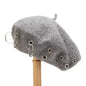 Metal ring embellished Trendsi beret hat featuring a stylish, round design with decorative metal accents on soft fabric.