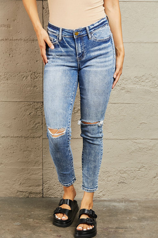 BAYEAS mid-rise distressed skinny jeans by Trendsi, featuring a fitted silhouette with ripped details and classic denim wash.